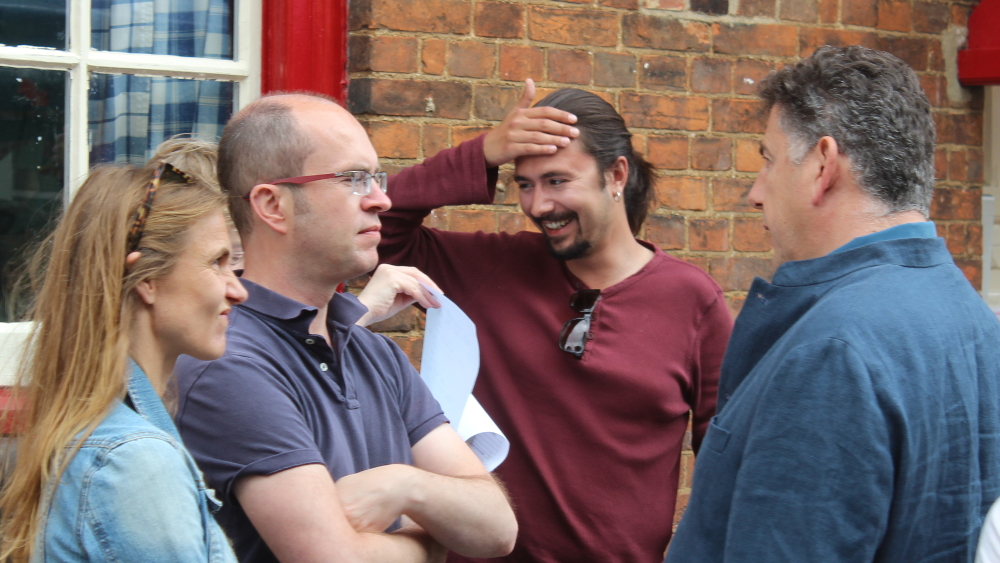 Johnny Sandelson (right), the Wharf developer,  probably spinning a different explanation, to the apparent surprise of Marco Dias, second on  the right, one of the JCA trustees.