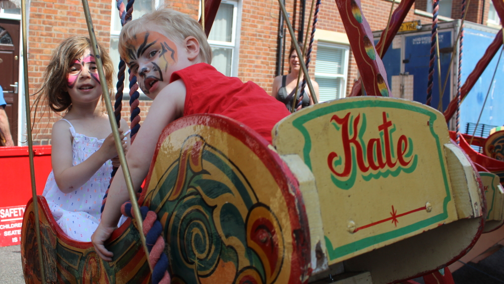 Swing time in Canal Street, enjoying the fairground attractions
