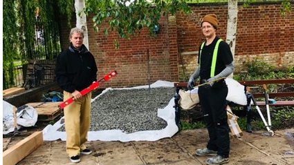 <p>The pitch was constructed by local volunteers.&nbsp;Bryan Hokum (left) and Curtis Campbell, who&nbsp;complete the foundation of recycled foam glass</p>